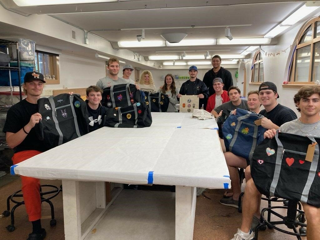 Flagler College students display the personalized bags they helped create for youth in the care of the St. Johns County Family Integrity Program.